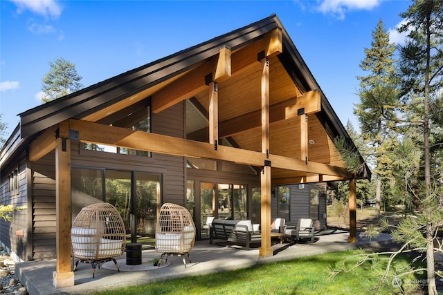 back of property with a patio and an outdoor living space