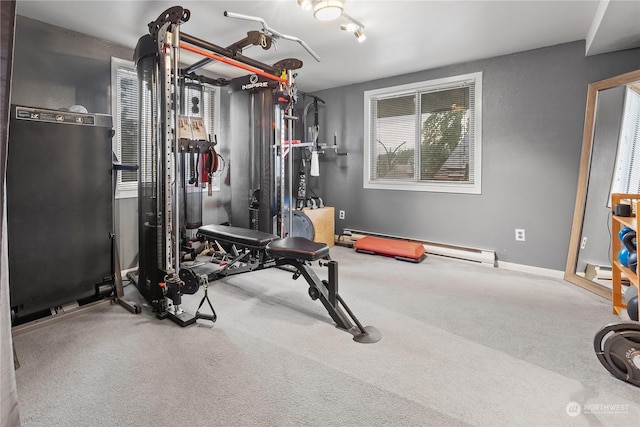 workout area featuring a baseboard heating unit