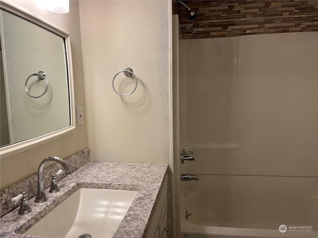 bathroom with shower / washtub combination and vanity