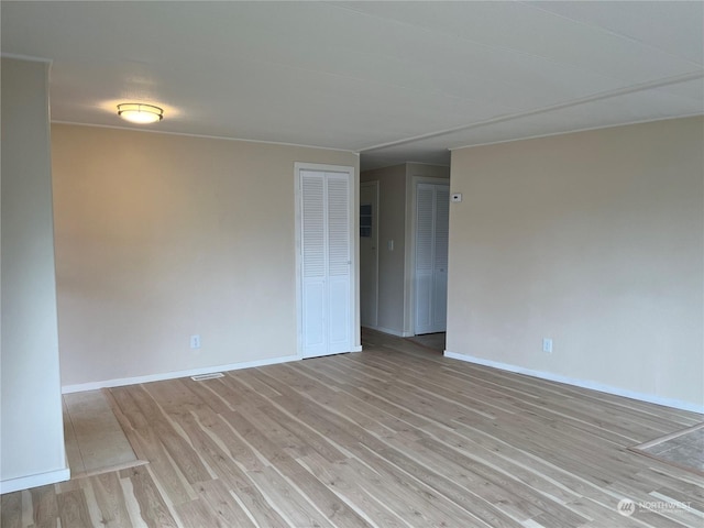 empty room with light wood-type flooring