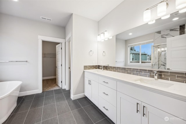 bathroom featuring vanity, backsplash, and independent shower and bath