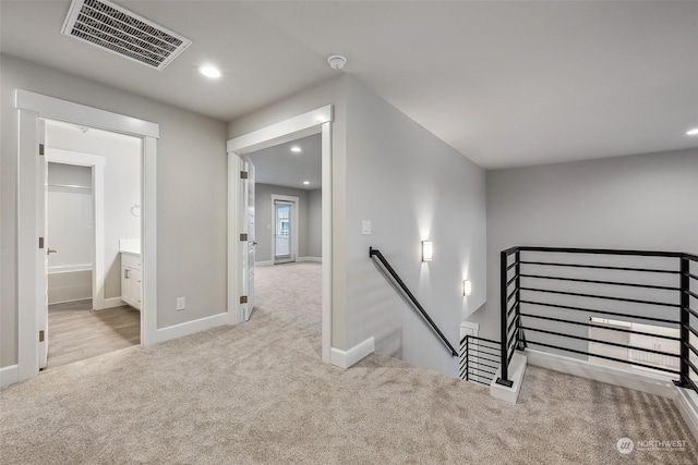 stairway featuring carpet floors