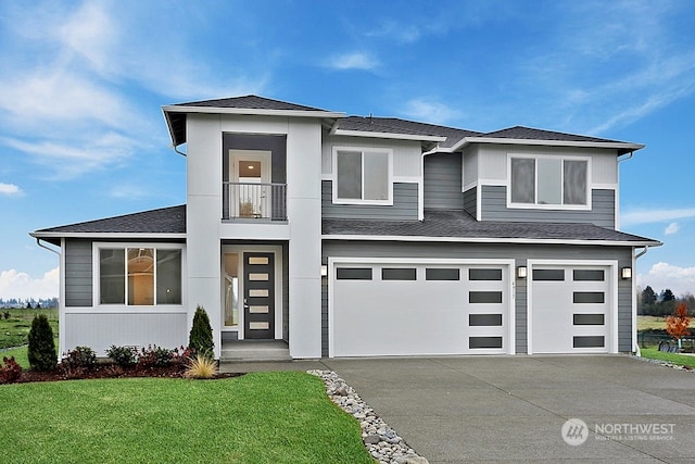 prairie-style house with a garage, a balcony, and a front lawn