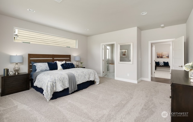 carpeted bedroom featuring connected bathroom