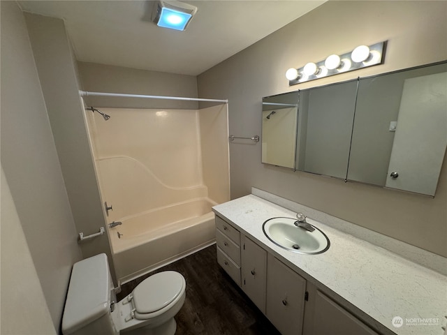 full bathroom with washtub / shower combination, hardwood / wood-style flooring, toilet, and large vanity