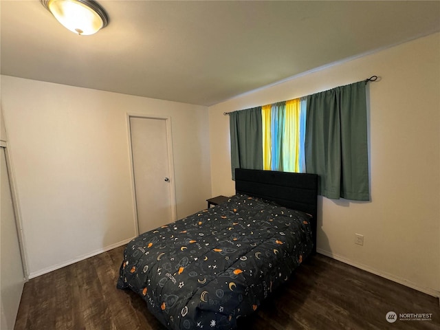 bedroom with wood finished floors and baseboards