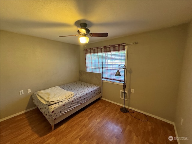 bedroom featuring hardwood / wood-style flooring and ceiling fan