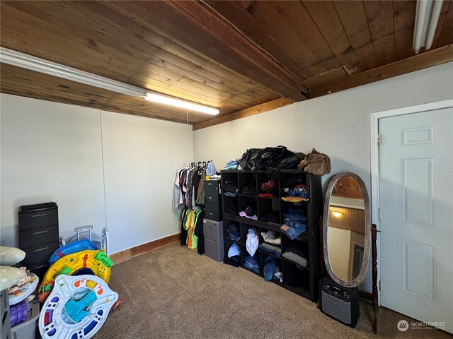 rec room with carpet, beam ceiling, and wood ceiling