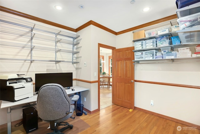 office area with crown molding and light wood-type flooring