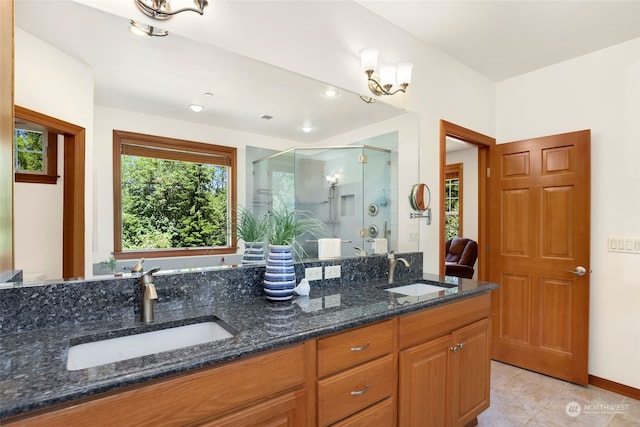 bathroom featuring double sink vanity, an enclosed shower, and tile patterned flooring