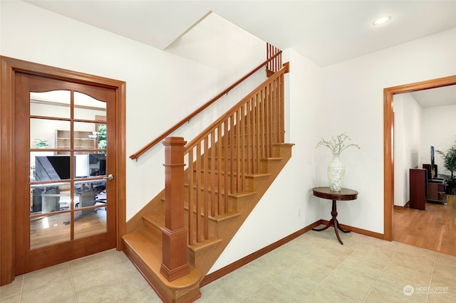 stairs with light wood-type flooring