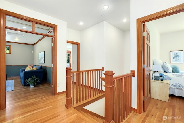 hall featuring crown molding and light wood-type flooring