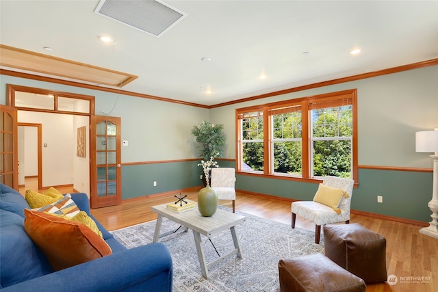 living room with crown molding, french doors, and hardwood / wood-style floors