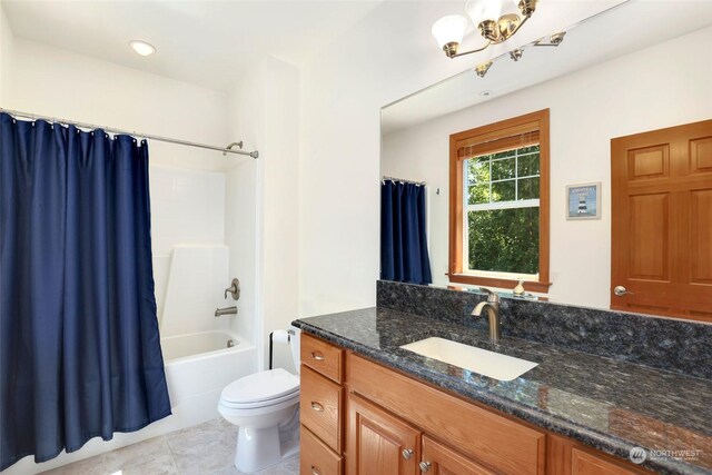 full bathroom with vanity, shower / bath combo, tile patterned flooring, and toilet