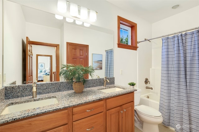 full bathroom with dual vanity, toilet, and shower / bath combo