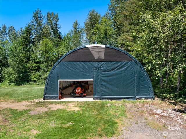 view of outbuilding featuring a lawn