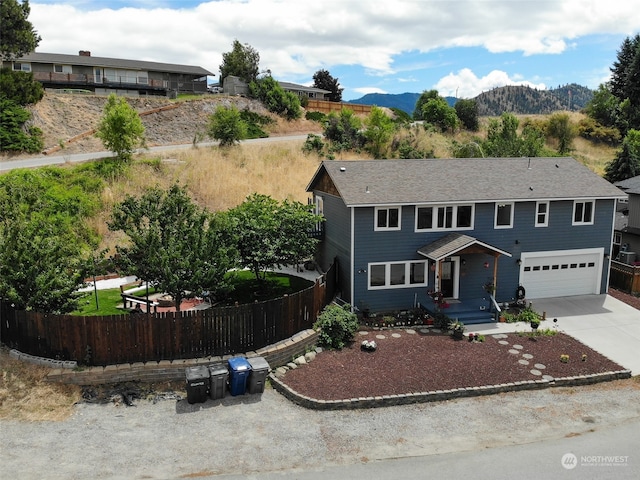 view of front of property featuring a garage and a mountain view