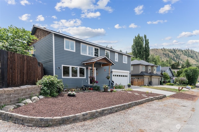 view of property featuring a garage and a mountain view