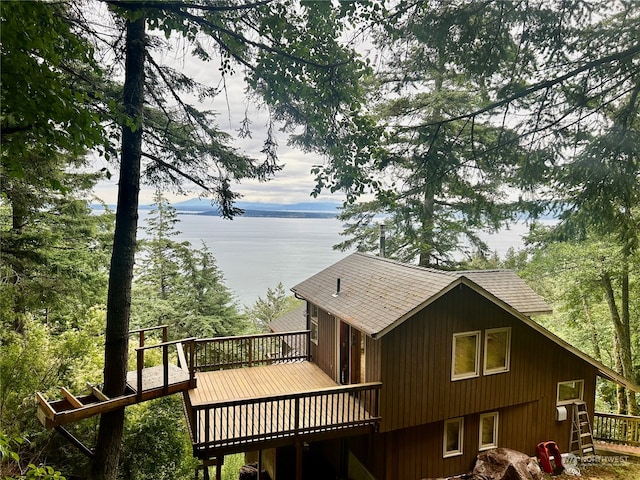 exterior space featuring a deck with water view