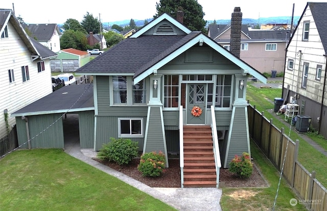 back of house with a yard and central AC