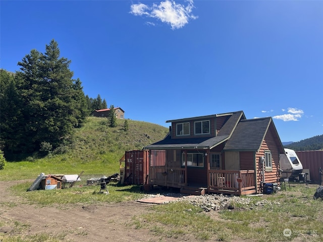 back of property featuring a wooden deck