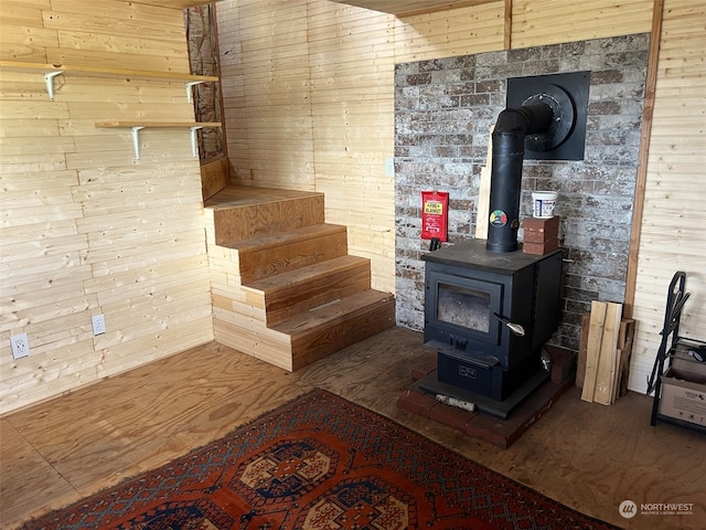 living room with wooden walls and a wood stove