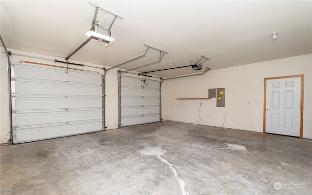garage with electric panel and a garage door opener