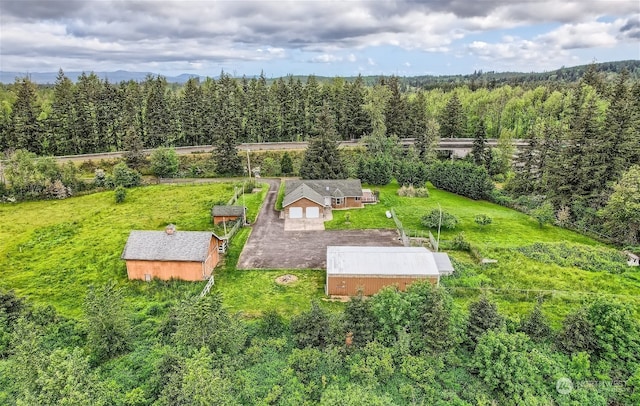 aerial view featuring a wooded view