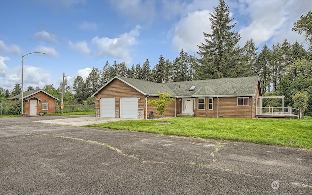 ranch-style home featuring a front yard and a garage