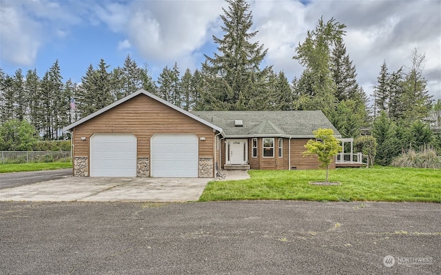 view of front of property with a front yard and a garage