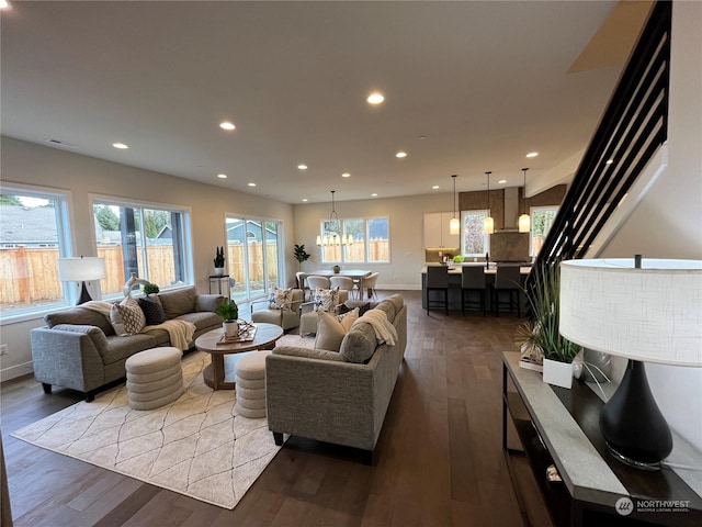 living room with wood-type flooring and an inviting chandelier