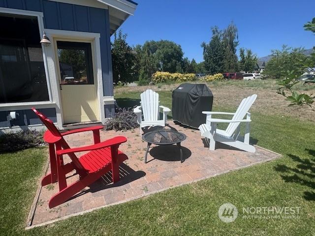 view of patio / terrace with grilling area and a fire pit