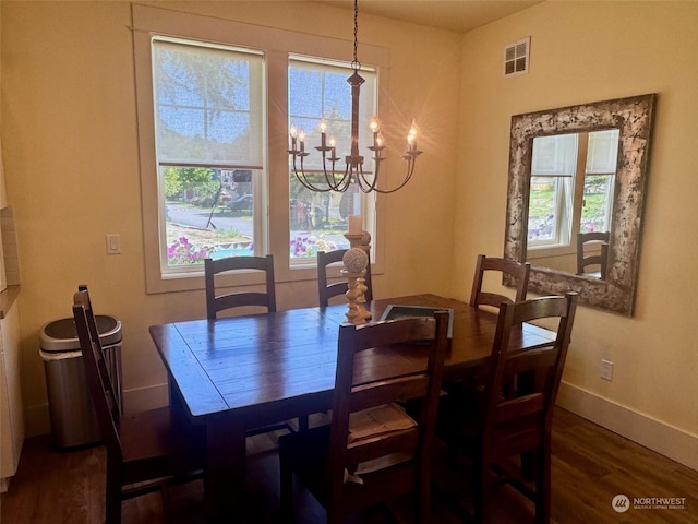 dining room featuring dark hardwood / wood-style floors and a chandelier