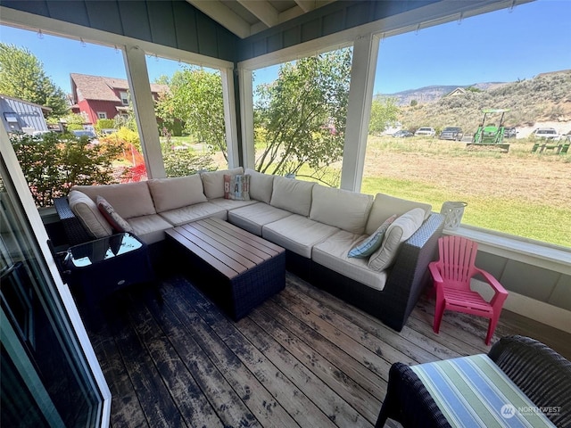 sunroom featuring a mountain view