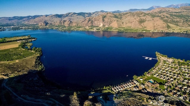 drone / aerial view with a water and mountain view