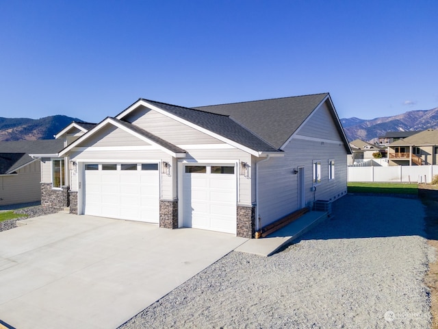 view of front of house featuring a garage and a mountain view