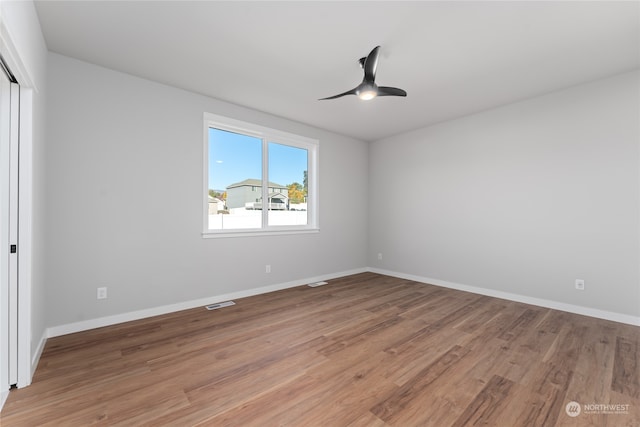 spare room with hardwood / wood-style flooring and ceiling fan