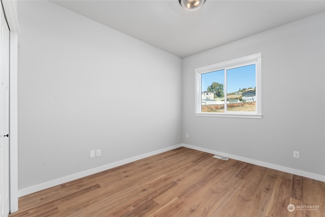 unfurnished room with light wood-type flooring