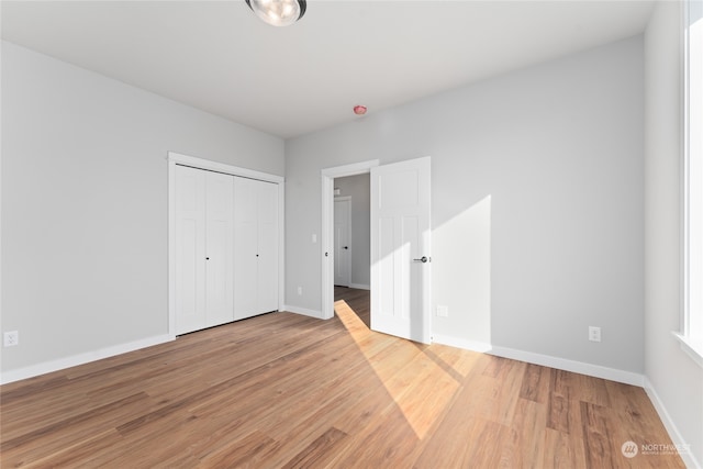 unfurnished bedroom featuring hardwood / wood-style floors and a closet