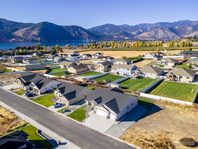 drone / aerial view with a water and mountain view