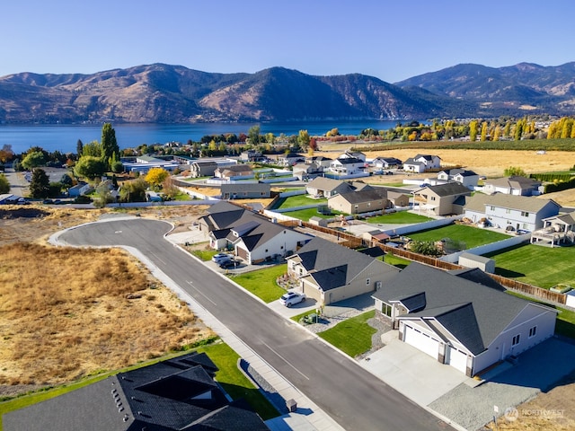 aerial view featuring a water and mountain view