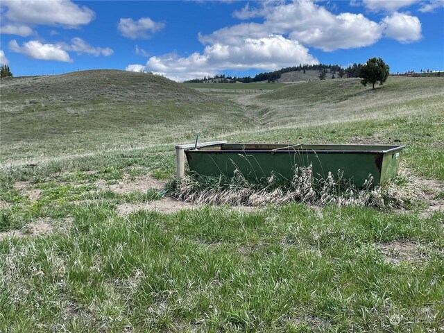 view of property exterior with a mountain view and a rural view