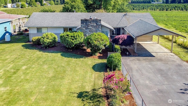 view of front of property featuring a carport and a front lawn