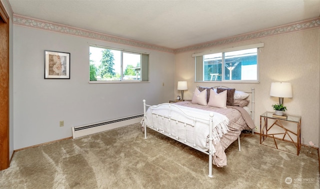 bedroom with a baseboard heating unit and carpet floors