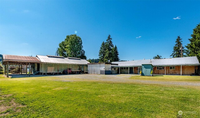 view of front of house with an outdoor structure and a front yard