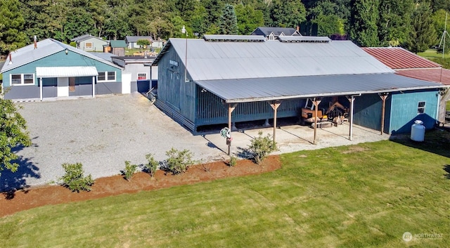 exterior space with an outdoor structure and a front yard