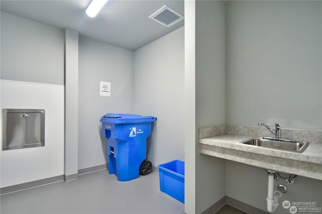 bathroom with sink and concrete floors