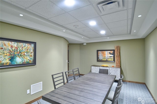 dining area featuring a drop ceiling