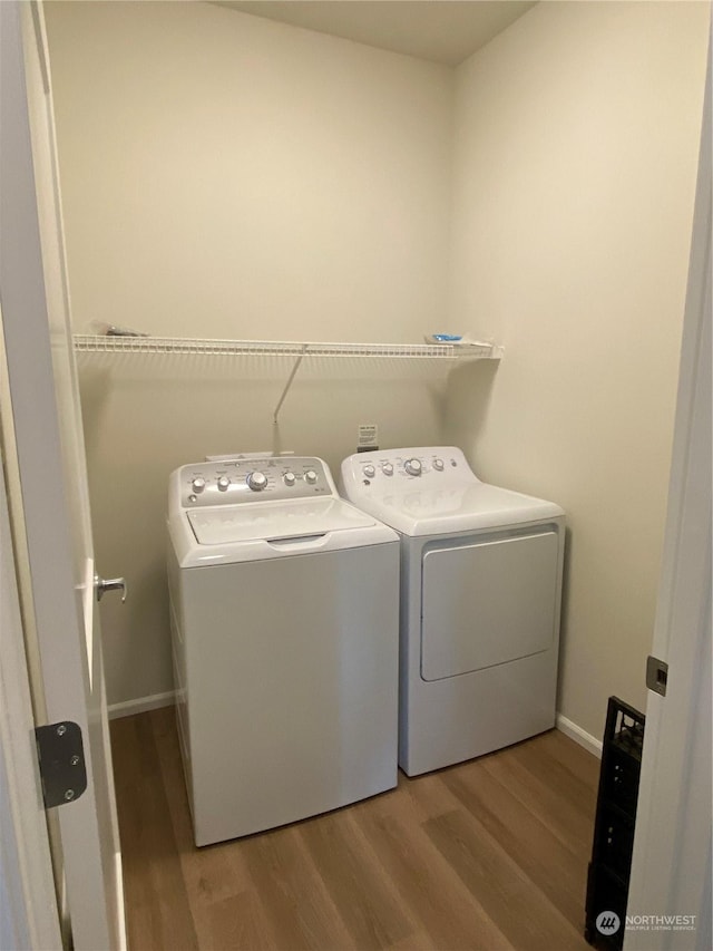 washroom featuring hardwood / wood-style floors and washer and clothes dryer