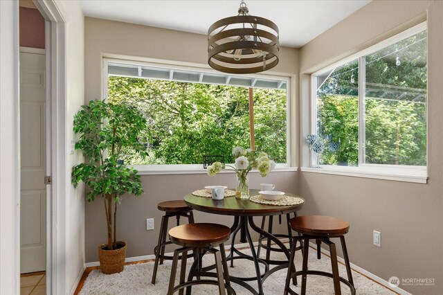 sunroom featuring a notable chandelier